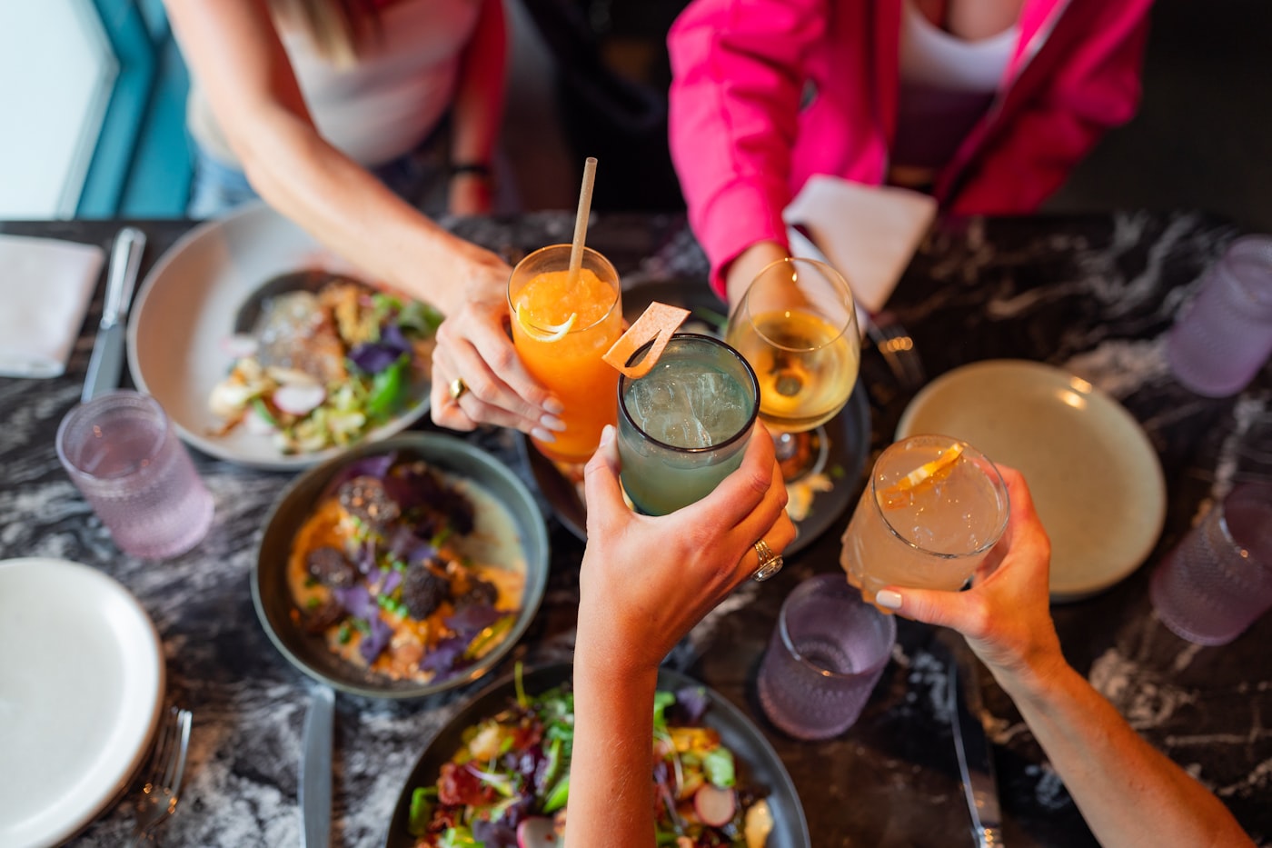 A group of friends sharing a meal together at a restaurant table